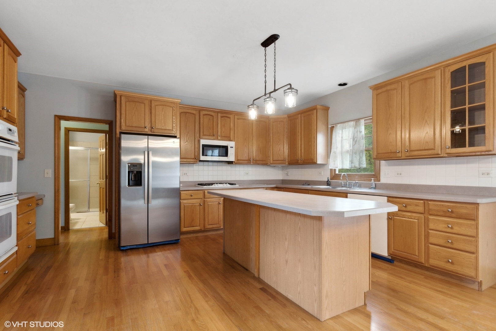 2908 Beth Lane Naperville, IL 60564 - Photo 5 of 21 a kitchen with stainless steel appliances granite countertop a refrigerator a sink dishwasher a stove with wooden floor and cabinets