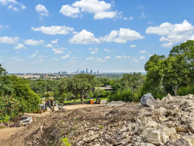 a view of a road with buildings in the background