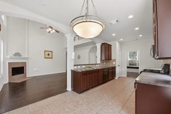 a kitchen with a refrigerator and a stove top oven