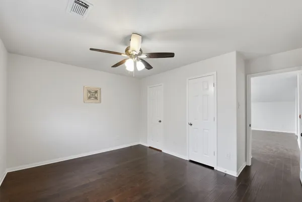 a view of an empty room and wooden floor