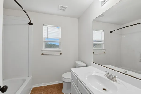 a bathroom with a sink toilet and mirror