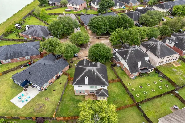 an aerial view of a house with a garden and swimming pool
