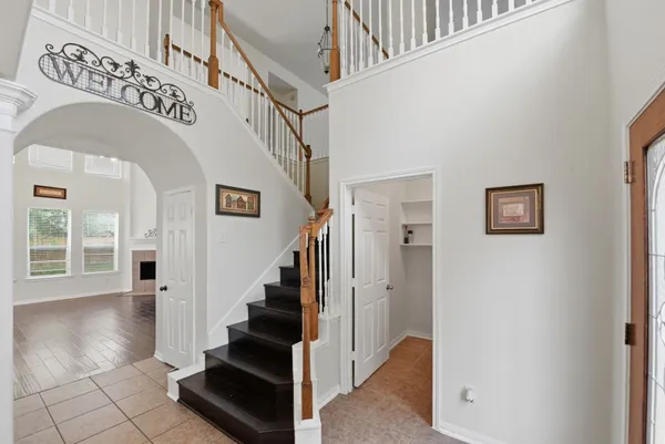 a view of a livingroom with wooden floor and a ceiling fan