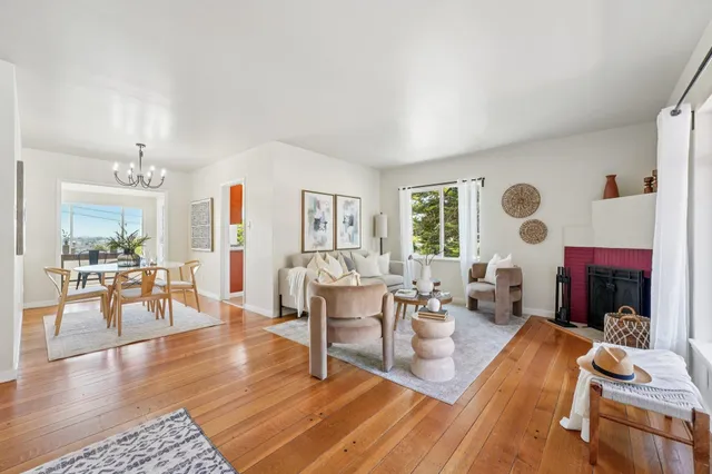 a living room with fireplace furniture and a large window