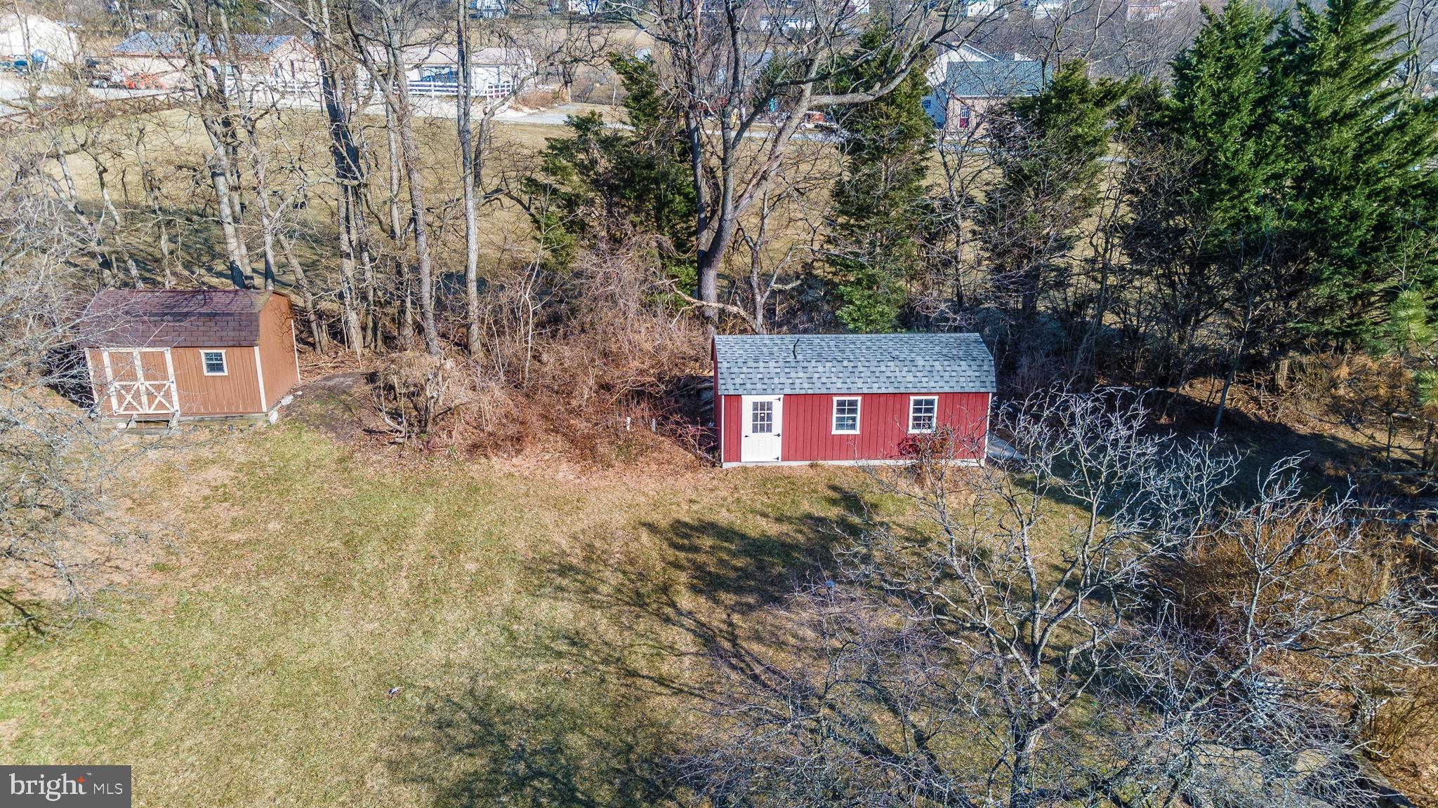 20824 Netz Road Boonsboro, MD 21713 - Photo 21 of 53 a view of a red brick house with a large tree