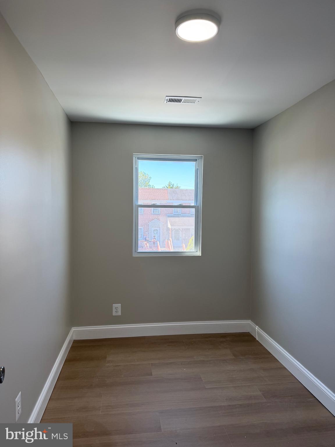 212 West Riverview Road Baltimore, MD 21225 - Photo 17 of 27 a view of an empty room with wooden floor and a window