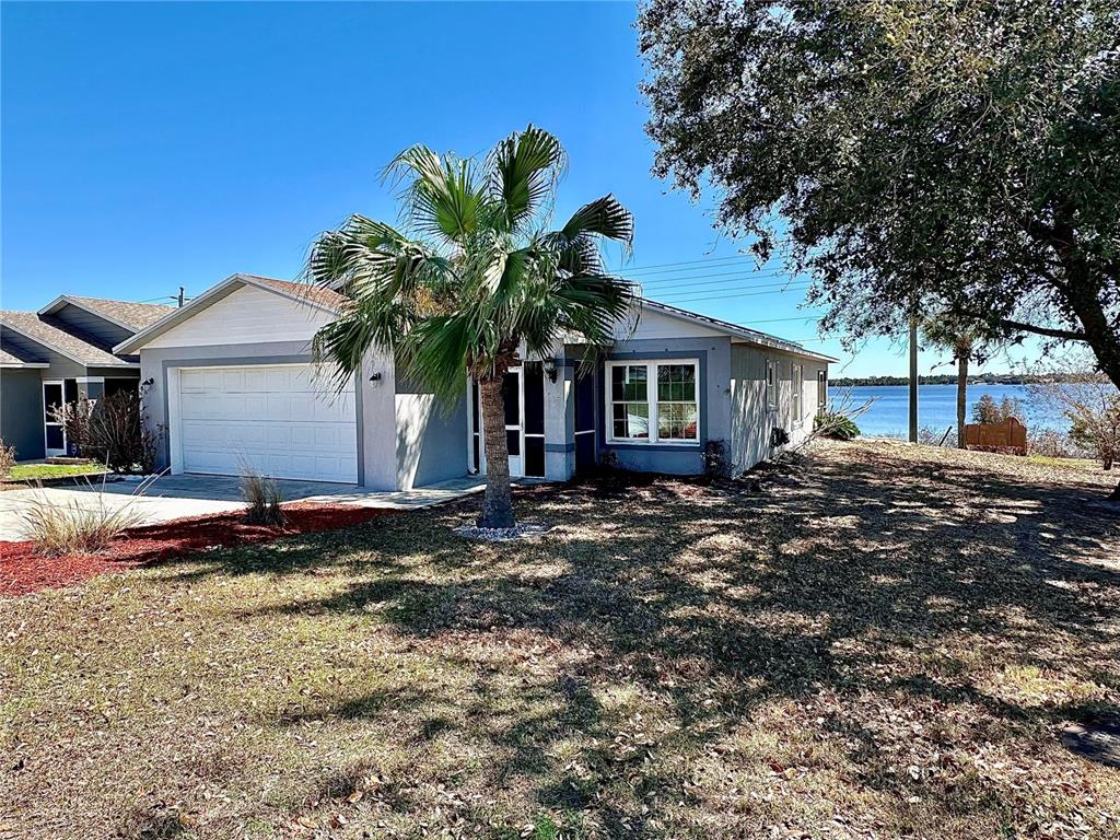 802 Marcia Loop Winter Haven, FL 33884 - Photo 1 of 48 a house that has a tree in front of it