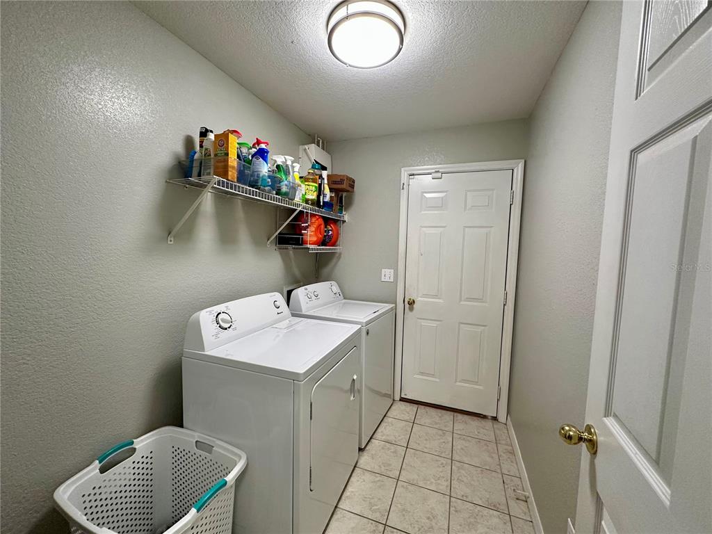802 Marcia Loop Winter Haven, FL 33884 - Photo 12 of 48 a storage room with washer and dryer