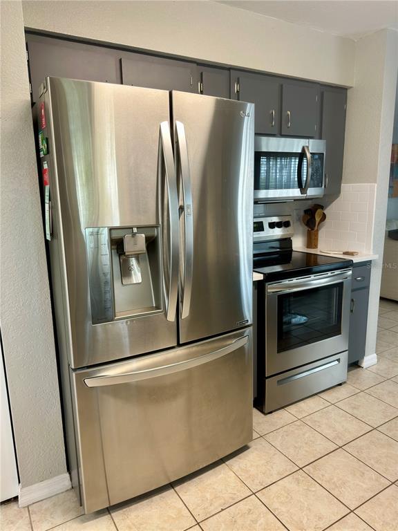 802 Marcia Loop Winter Haven, FL 33884 - Photo 16 of 48 a metallic refrigerator freezer sitting in a kitchen