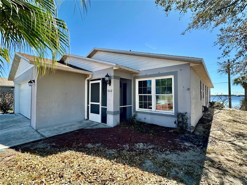 802 Marcia Loop Winter Haven, FL 33884 - Photo 25 of 48 a front view of a house with garden