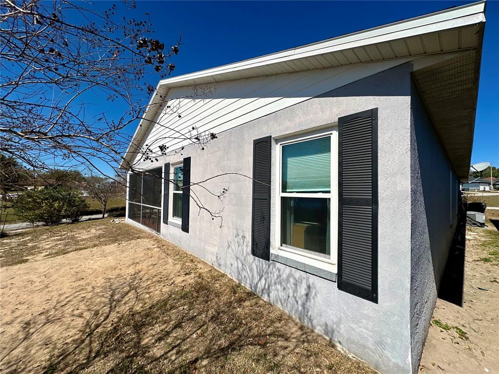 802 Marcia Loop Winter Haven, FL 33884 - Photo 28 of 48 a view of a porch with a floor to ceiling window and potted plants