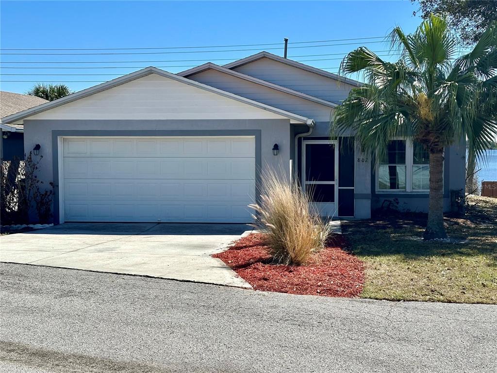 802 Marcia Loop Winter Haven, FL 33884 - Photo 3 of 48 a front view of a house with a yard