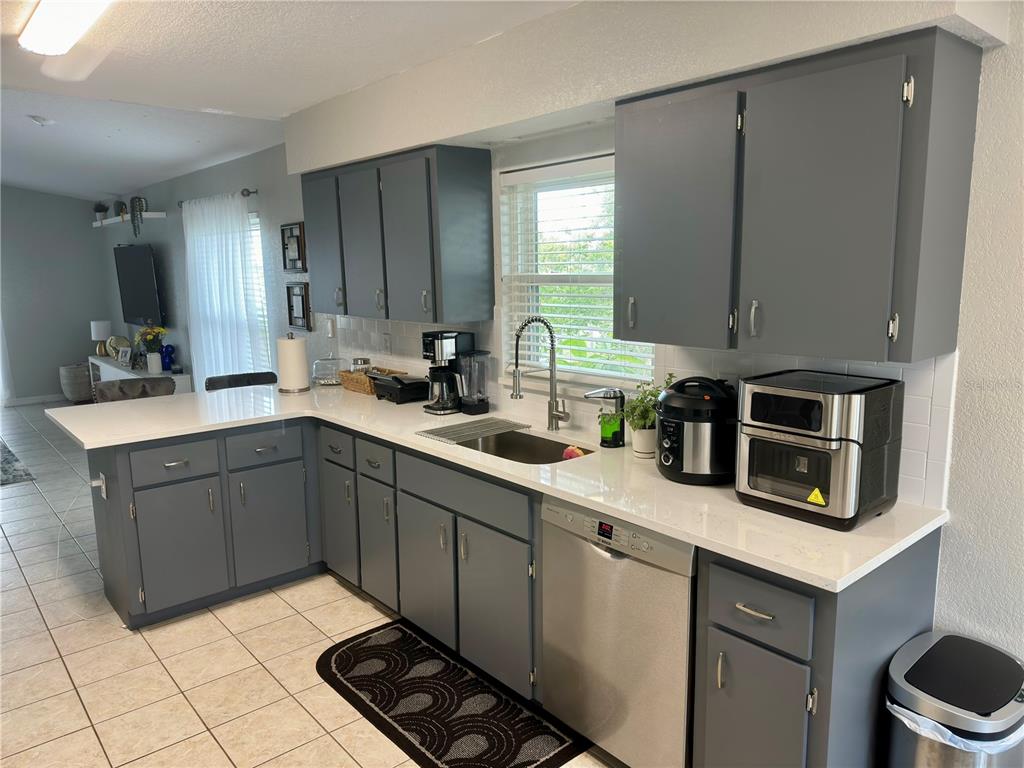 802 Marcia Loop Winter Haven, FL 33884 - Photo 6 of 48 a kitchen with a sink cabinets and window