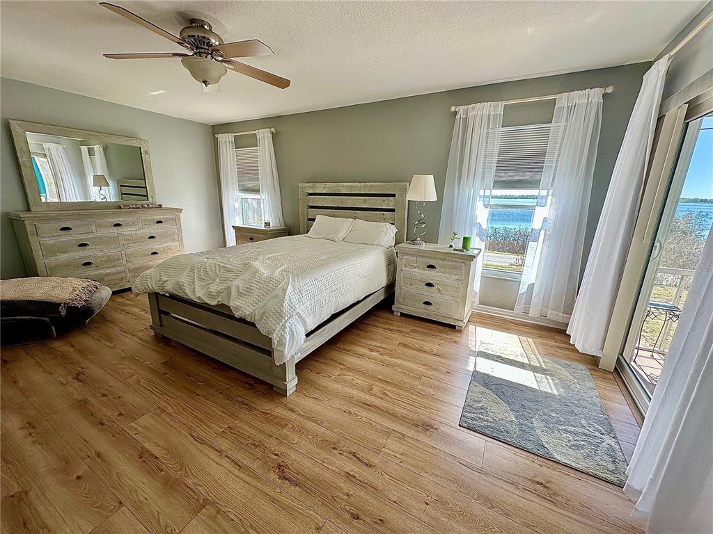 802 Marcia Loop Winter Haven, FL 33884 - Photo 7 of 48 a spacious bedroom with a bed and wooden floor