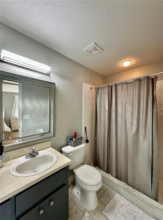 802 Marcia Loop Winter Haven, FL 33884 - Photo 10 of 48 a bathroom with a double vanity sink toilet and a mirror