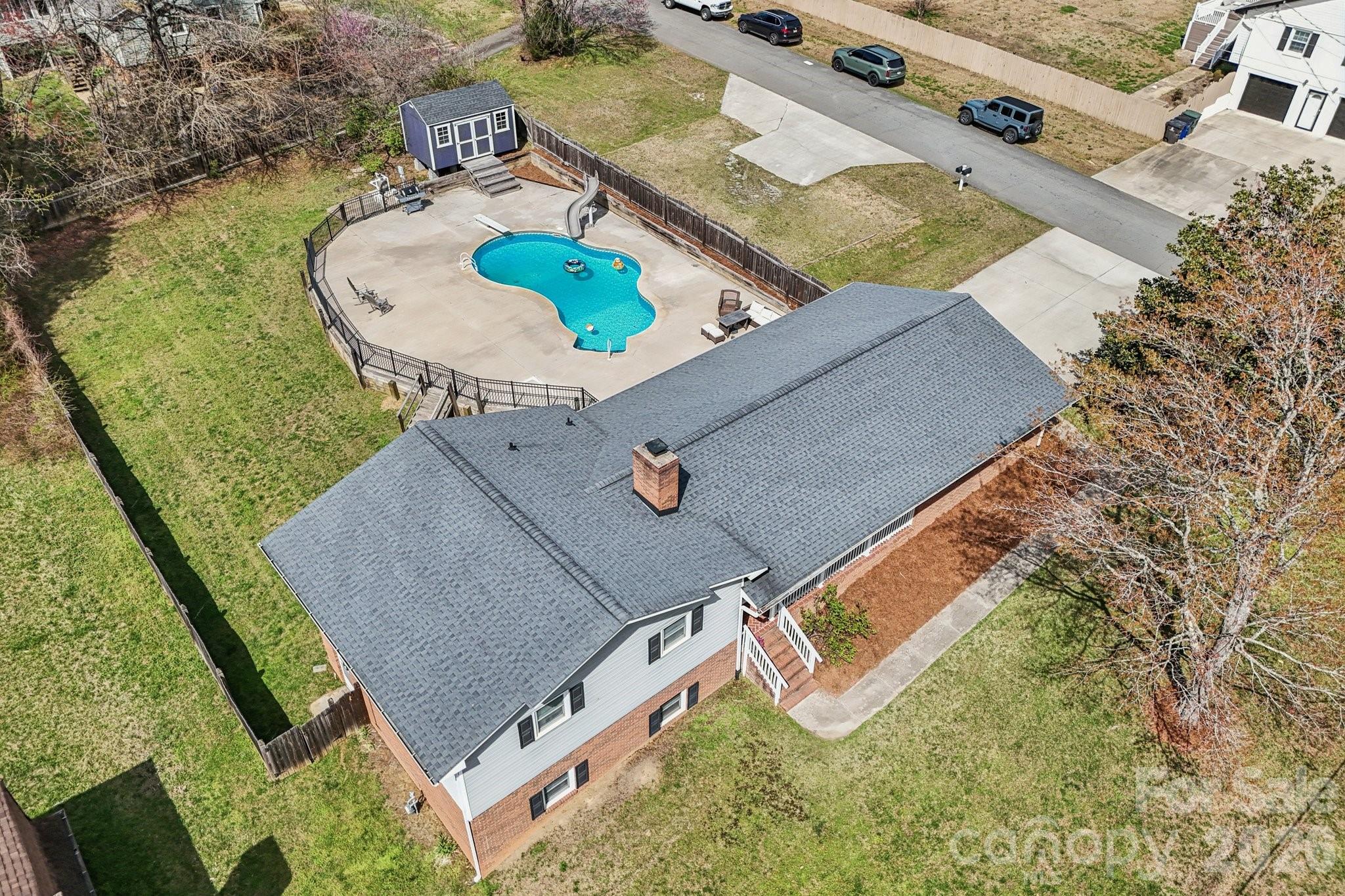 an aerial view of a house swimming pool and outdoor space