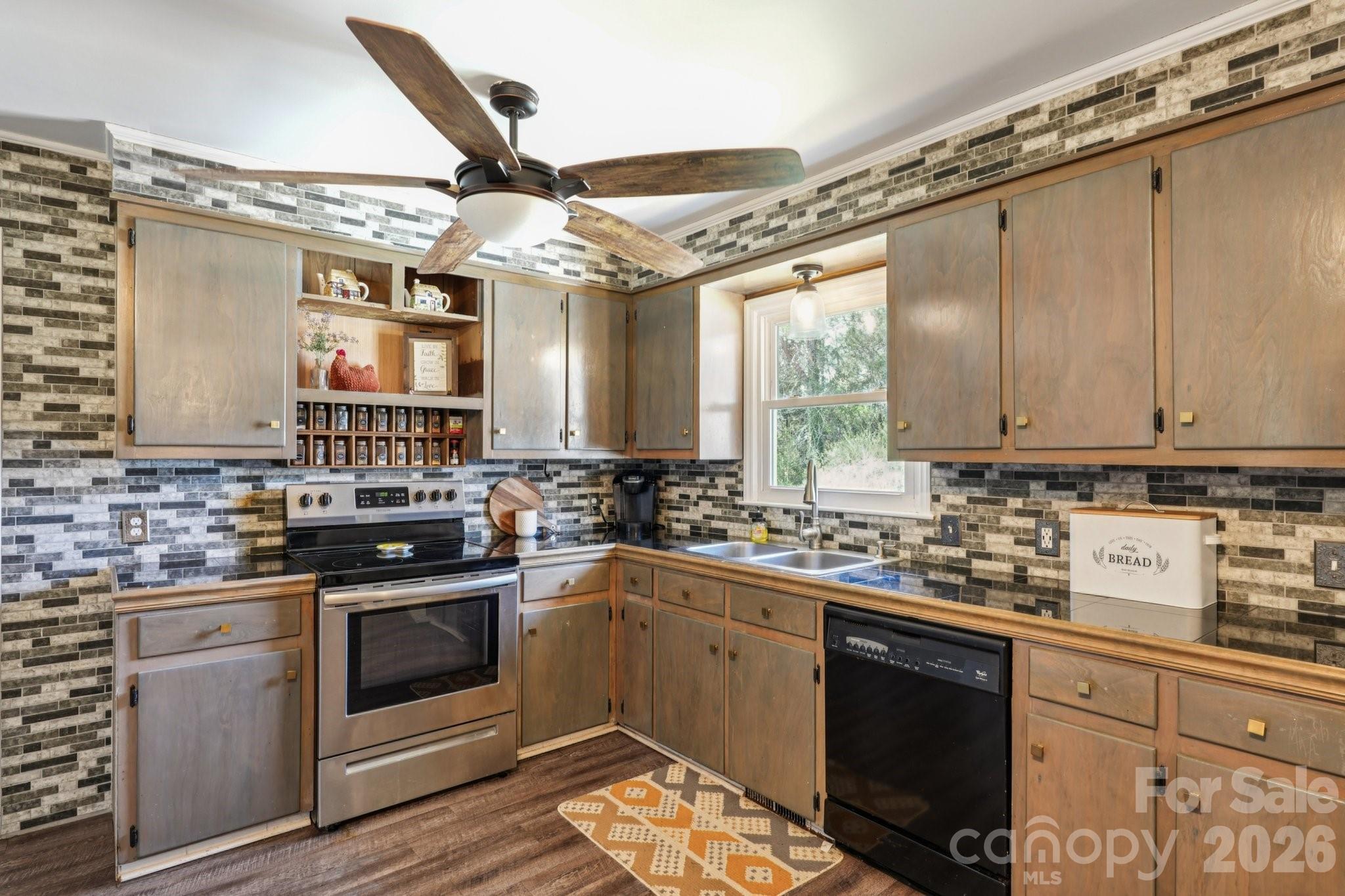 660 South Peace Haven Road Winston-Salem, NC 27103 - Photo 12 of 43 a kitchen with a sink stove and cabinets