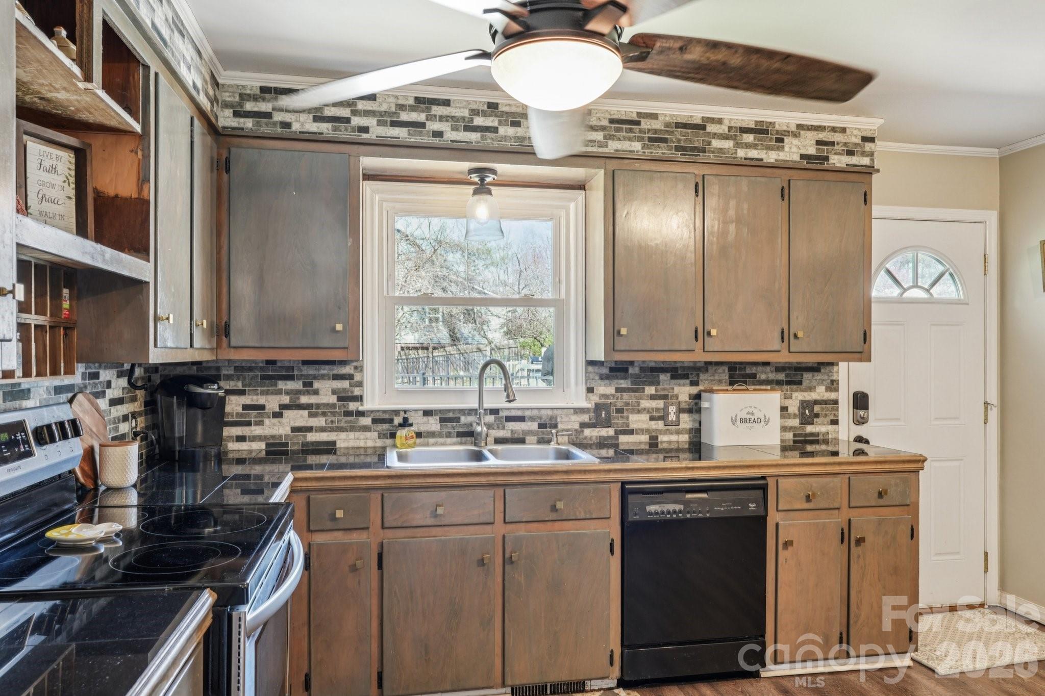 660 South Peace Haven Road Winston-Salem, NC 27103 - Photo 13 of 43 a kitchen with a sink stove and cabinets