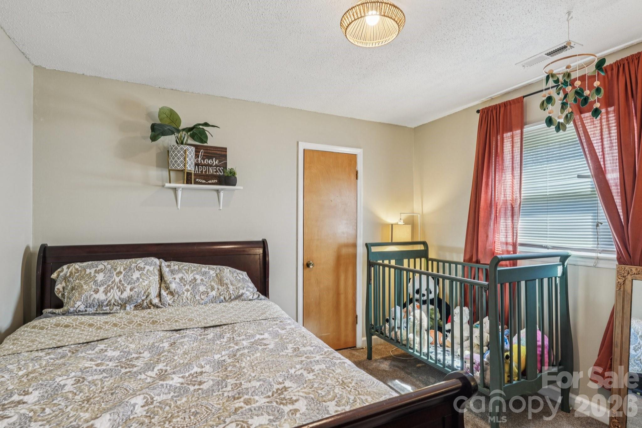 660 South Peace Haven Road Winston-Salem, NC 27103 - Photo 20 of 43 a bedroom with a bed and a window