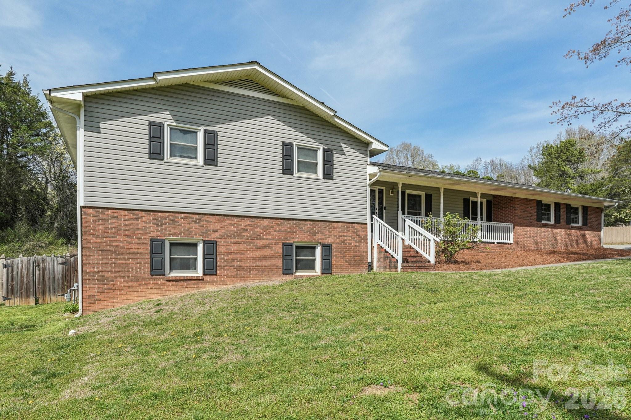 660 South Peace Haven Road Winston-Salem, NC 27103 - Photo 2 of 43 a front view of a house with a yard