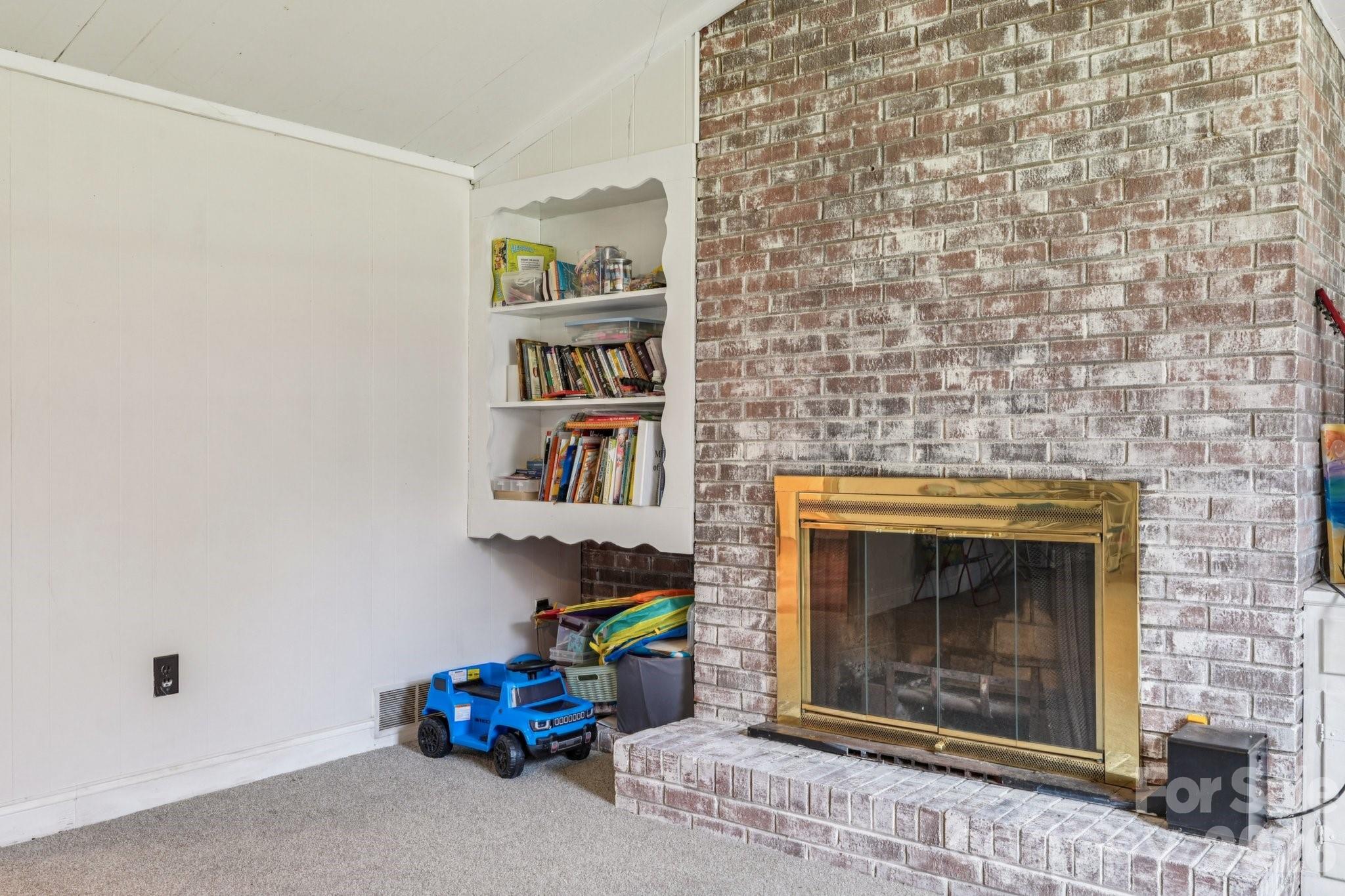 660 South Peace Haven Road Winston-Salem, NC 27103 - Photo 28 of 43 a living room with a fireplace