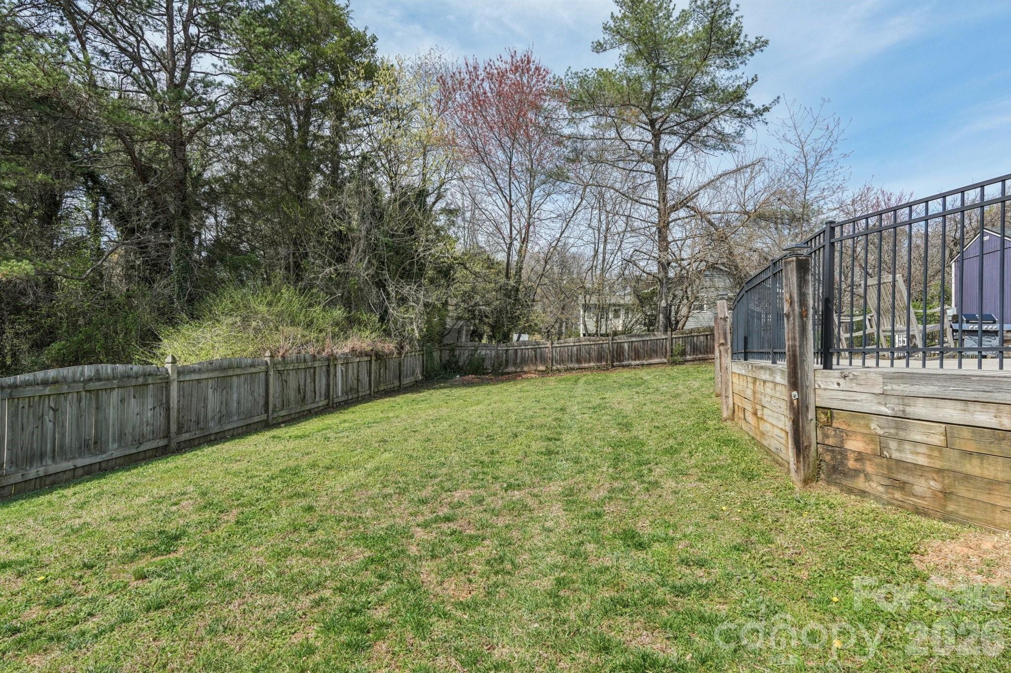 660 South Peace Haven Road Winston-Salem, NC 27103 - Photo 32 of 43 a view of backyard with large trees and wooden fence
