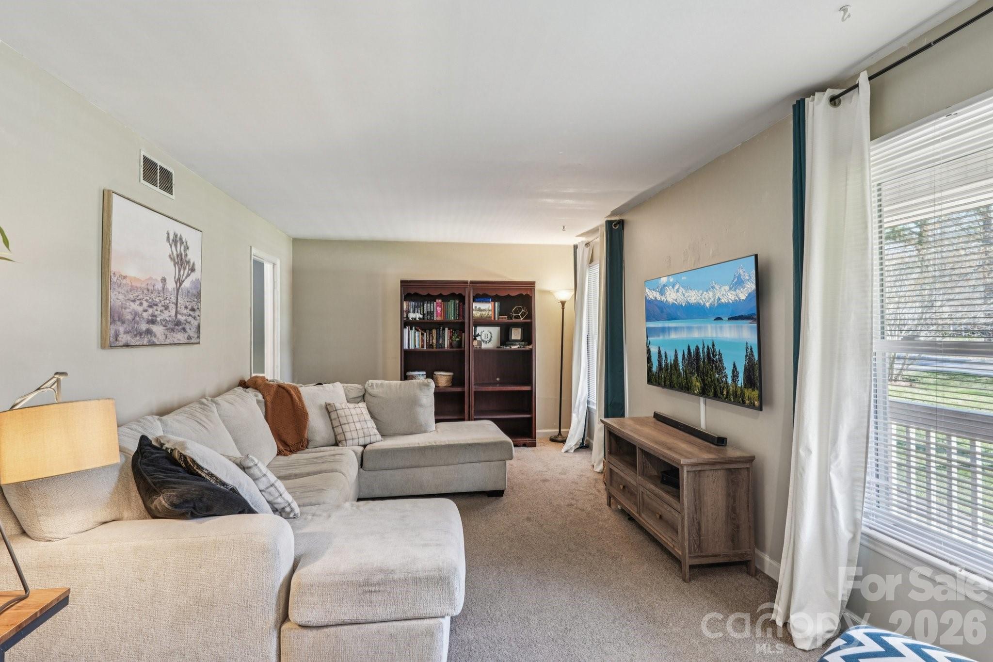 660 South Peace Haven Road Winston-Salem, NC 27103 - Photo 6 of 43 a living room with furniture and a flat screen tv