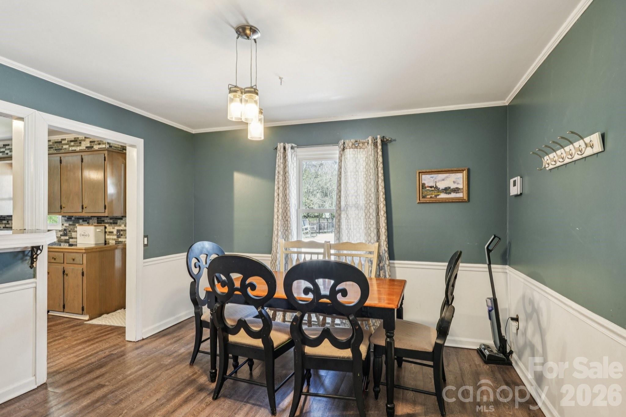 660 South Peace Haven Road Winston-Salem, NC 27103 - Photo 9 of 43 a view of a dining room with furniture window and wooden floor