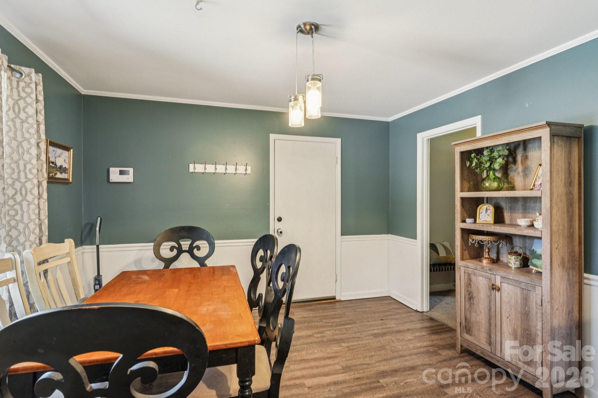 660 South Peace Haven Road Winston-Salem, NC 27103 - Photo 10 of 43 a view of a dining room with furniture window and wooden floor