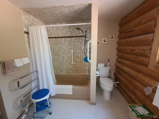 a bathroom with double vanity and a large mirror