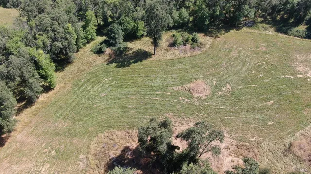 an aerial view of a house with a yard
