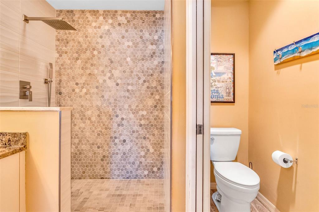 2090 Matecumbe Key Road, Unit 1105 Punta Gorda, FL 33955 - Photo 31 of 58 a white toilet sitting next to a shower curtain