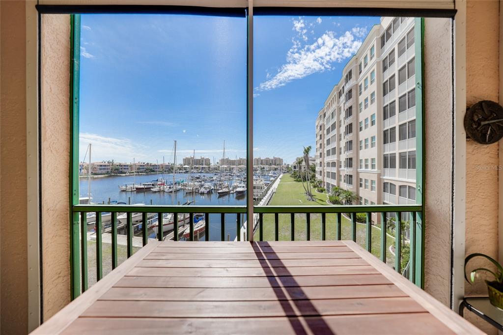 2090 Matecumbe Key Road, Unit 1105 Punta Gorda, FL 33955 - Photo 58 of 58 a view of a balcony with wooden floor and fence