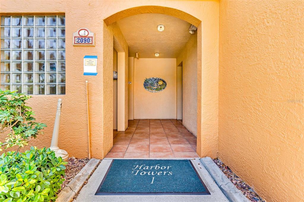 2090 Matecumbe Key Road, Unit 1105 Punta Gorda, FL 33955 - Photo 6 of 58 a view of a hallway with wooden floor and a potted plant