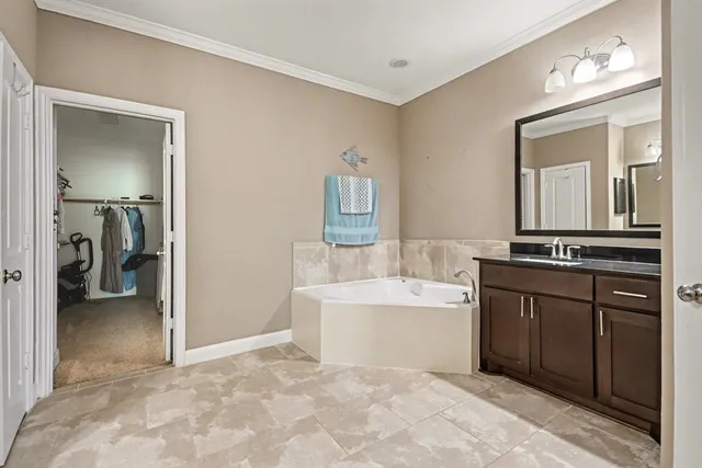 a spacious bathroom with a sink and a mirror