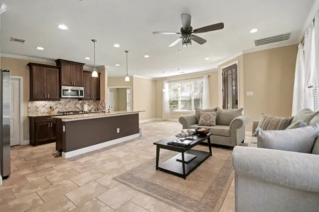 a living room with furniture and kitchen view