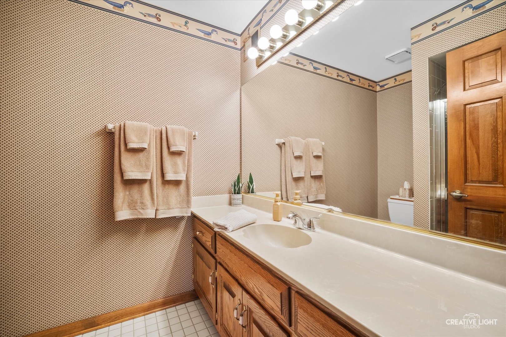 3112 Turnberry Road St. Charles, IL 60174 - Photo 26 of 43 a bathroom with a sink and a mirror