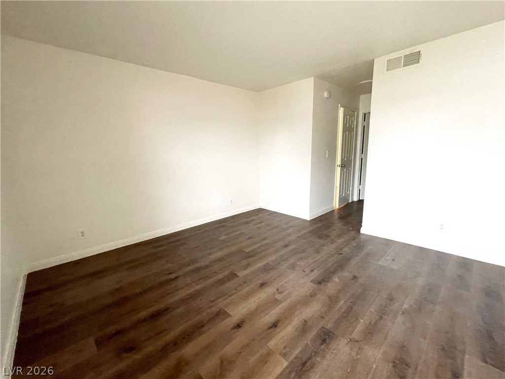 3135 South Mojave Road, Unit 221 Las Vegas, NV 89121 - Photo 9 of 19 Rich hardwood floors create a warm and inviting atmosphere in this versatile living space.