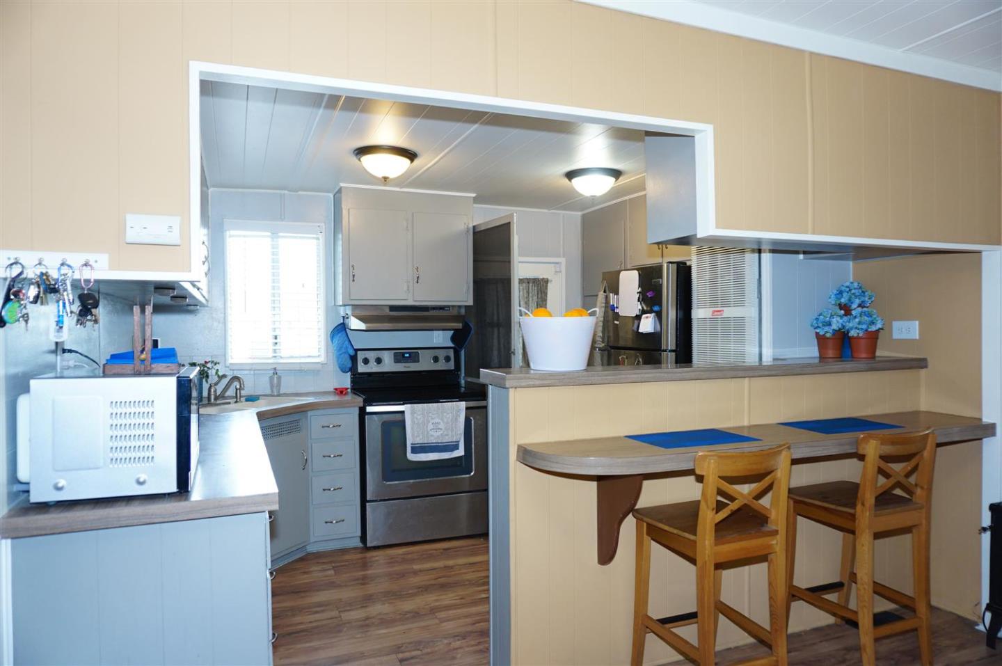 2150 Almaden Road, Unit 62 San Jose, CA 95125 - Photo 15 of 38 a kitchen with stainless steel appliances kitchen island granite countertop a sink and cabinets