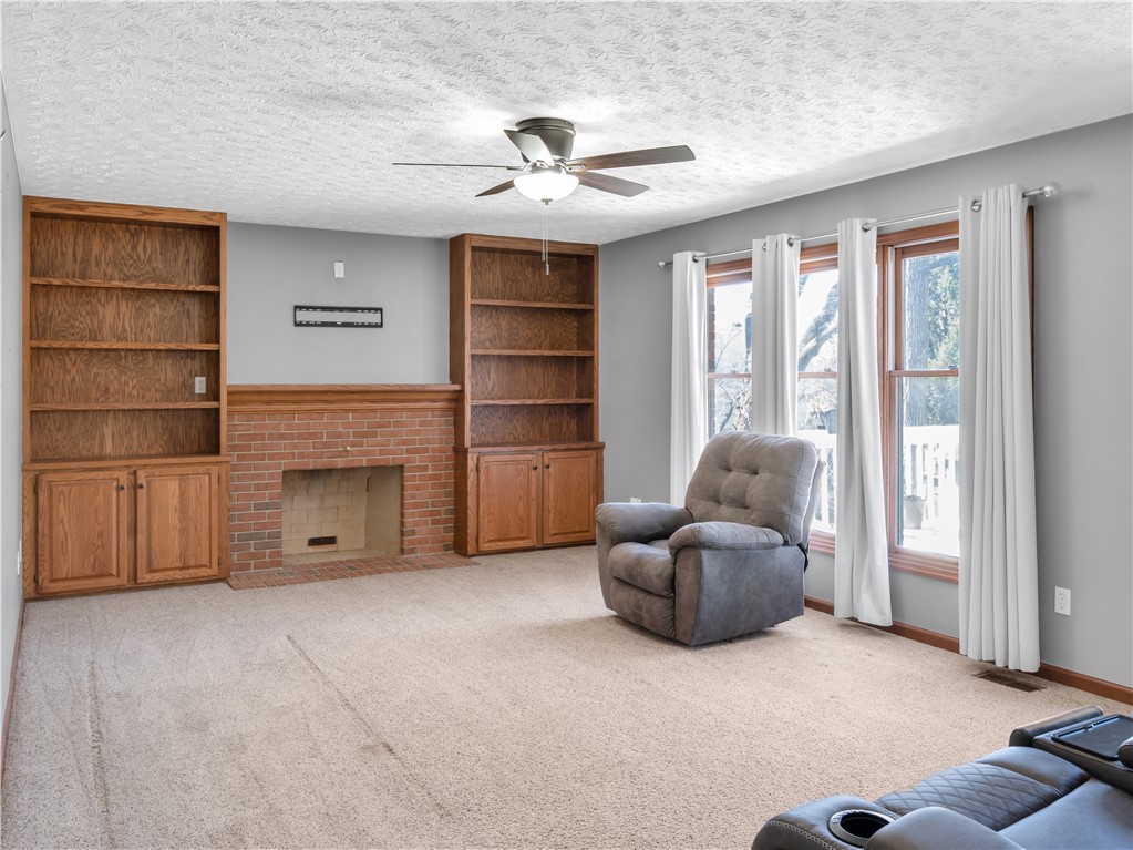 25 Callaway Springboro, OH 45066 - Photo 13 of 51 This inviting living room features a classic brick fireplace and ample built-in shelving.