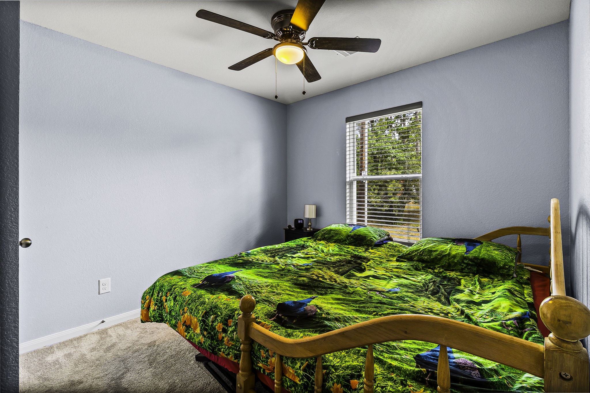155 Cherry Tree Livingston, TX 77351 - Photo 12 of 30 a bed sitting in a bedroom next to a window