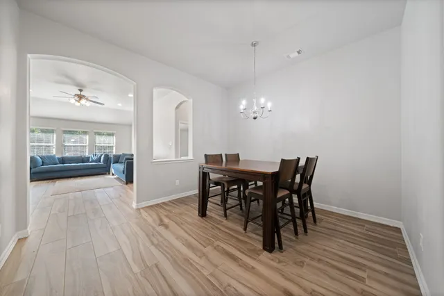 a view of a dining room with furniture and wooden floor