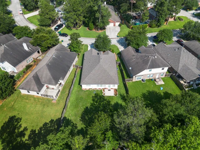 an aerial view of a house with a garden and swimming pool