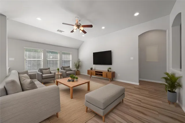 a living room with furniture and a flat screen tv