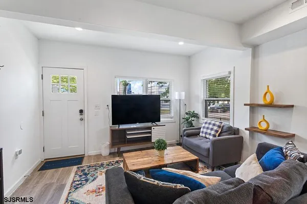 a kitchen with a table chairs a sink dishwasher refrigerator and cabinets