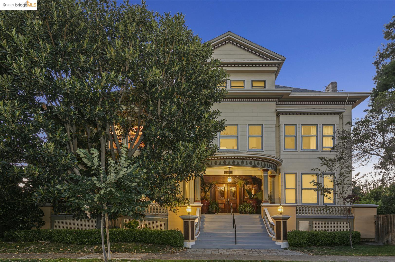 a front view of a house with a tree