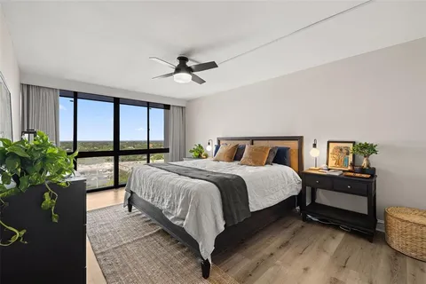a bedroom with a bed and a large window