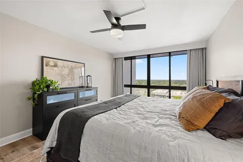a bedroom with bed and a potted plant