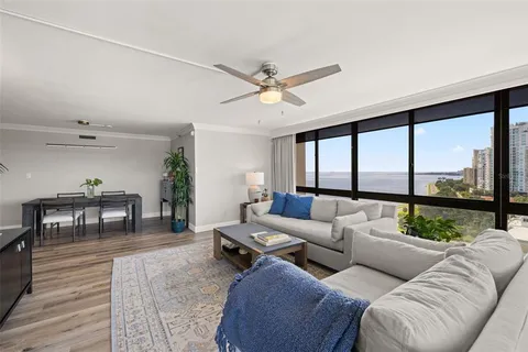 a living room with furniture a flat screen tv and a window