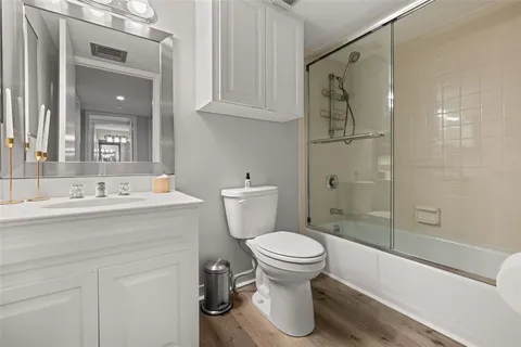 a bathroom with a toilet a sink and a large mirror